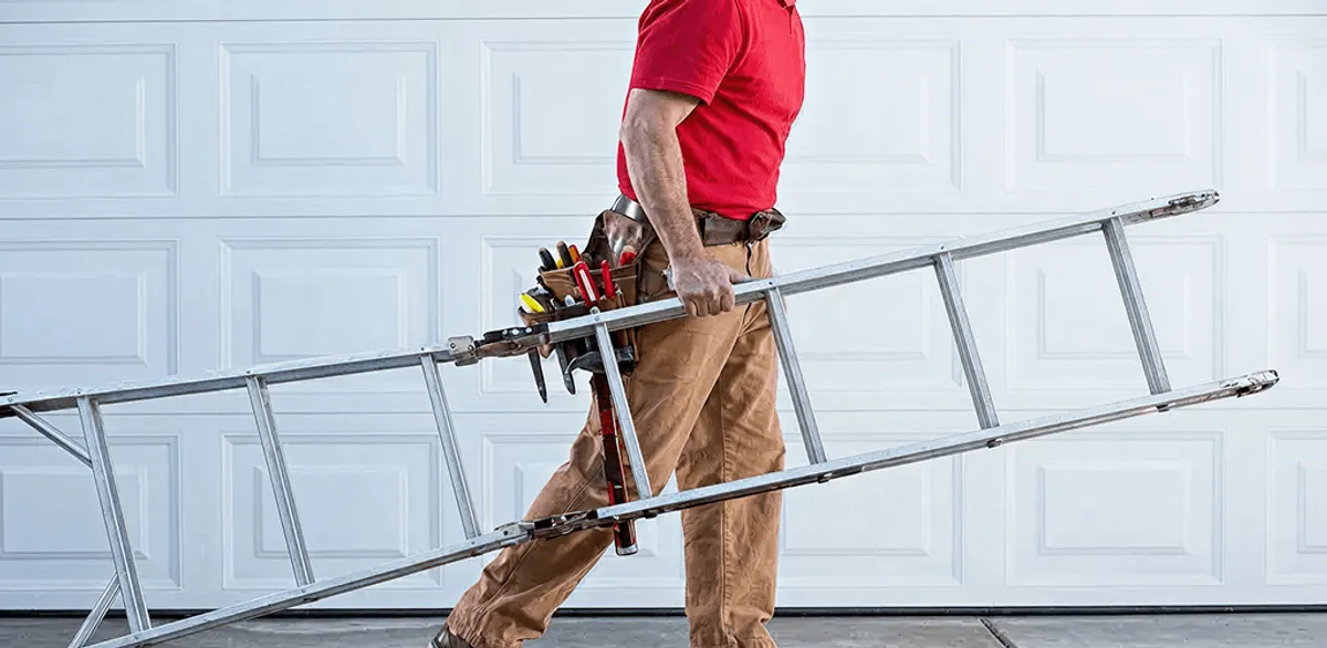 Garage door repair technician arriving with tools and ladder in Birmingham, AL