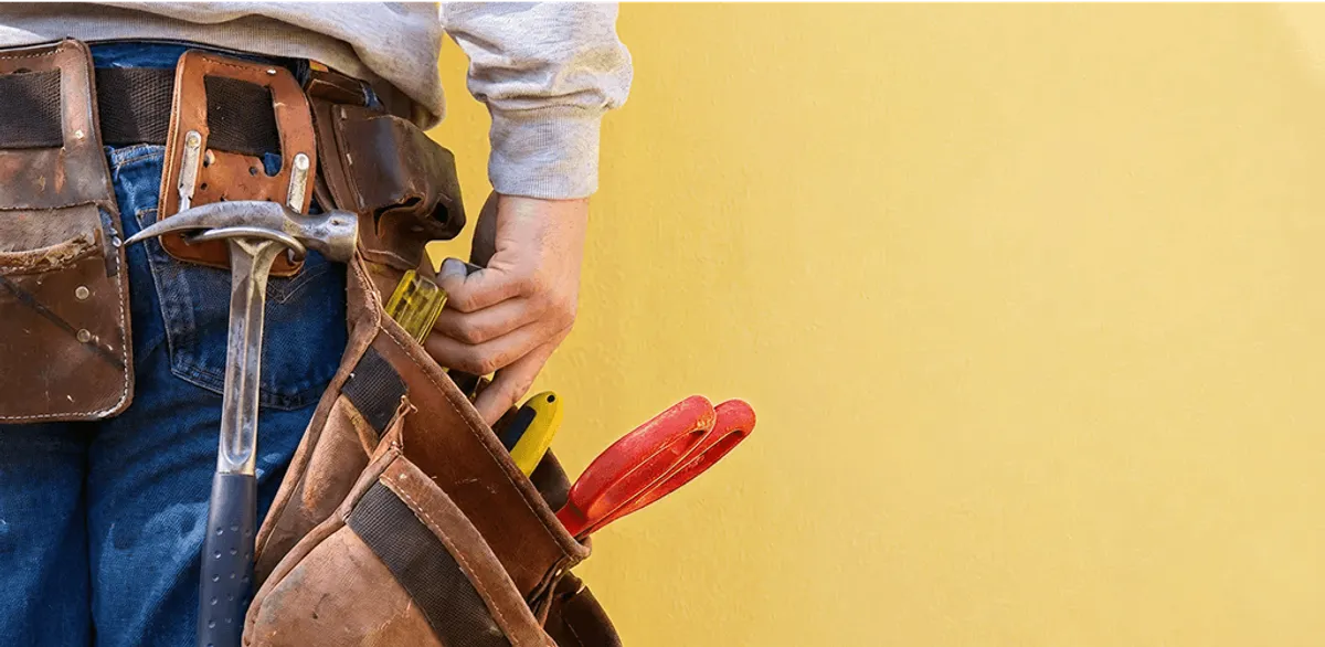 Handyman with tool belt ready for home repairs and maintenance in Birmingham, AL